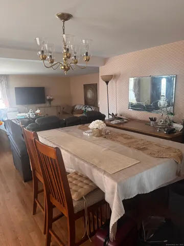 a dining room with a table chairs and a chandelier