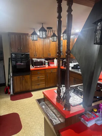 a living room with hard wood flooring and gym equipment