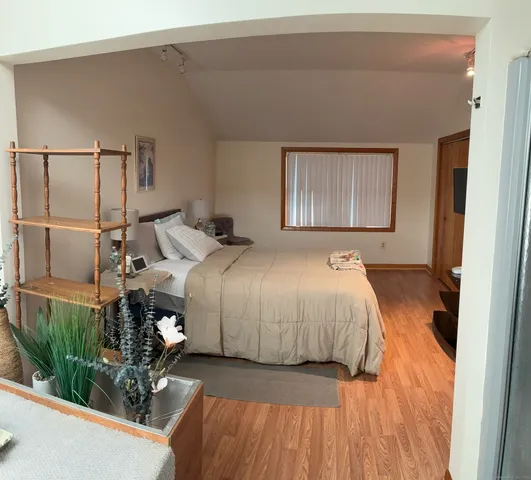 a bedroom with a bed and a window with outer view