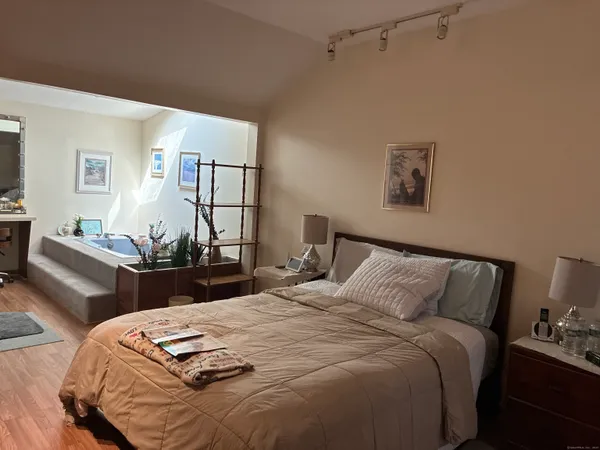 a bedroom with bed and a night stand