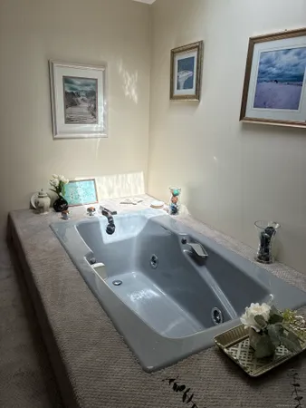 a bathroom with a granite countertop sink a mirror and bathtub