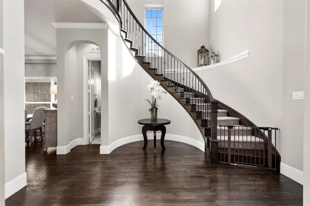 a view of entryway and hall with wooden floor