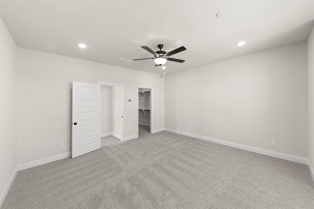 3900 Keya Drive Prosper, TX 75078 - Photo 28 of 36 an empty room with a ceiling fan and a window