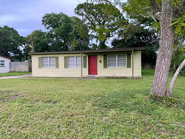 a front view of house with yard and trees
