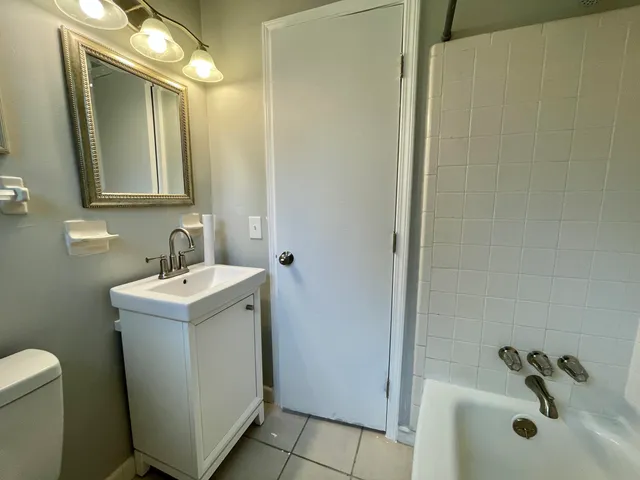 a bathroom with a toilet sink and mirror