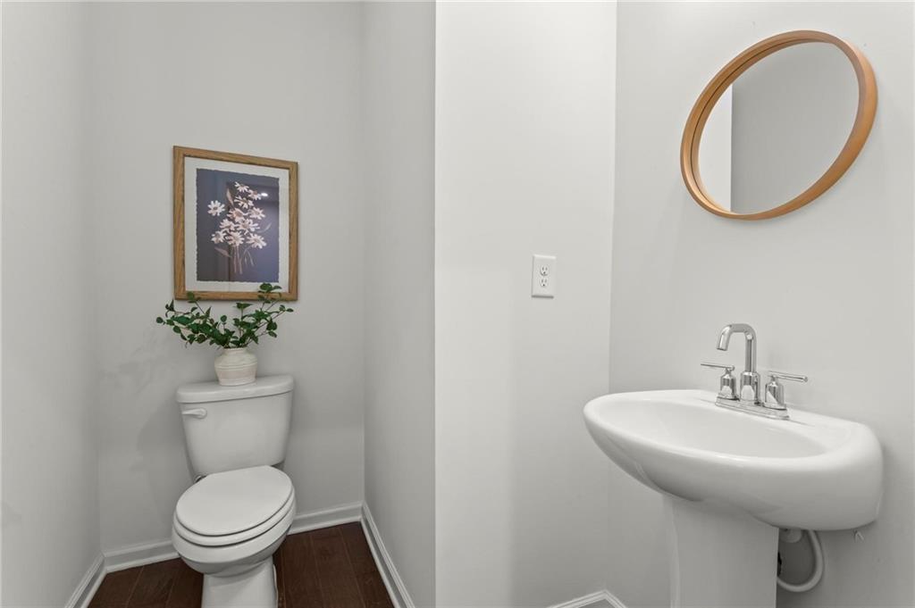 718 Needletail Way Atlanta, GA 30312 - Photo 4 of 44 a bathroom with a toilet a sink and a mirror