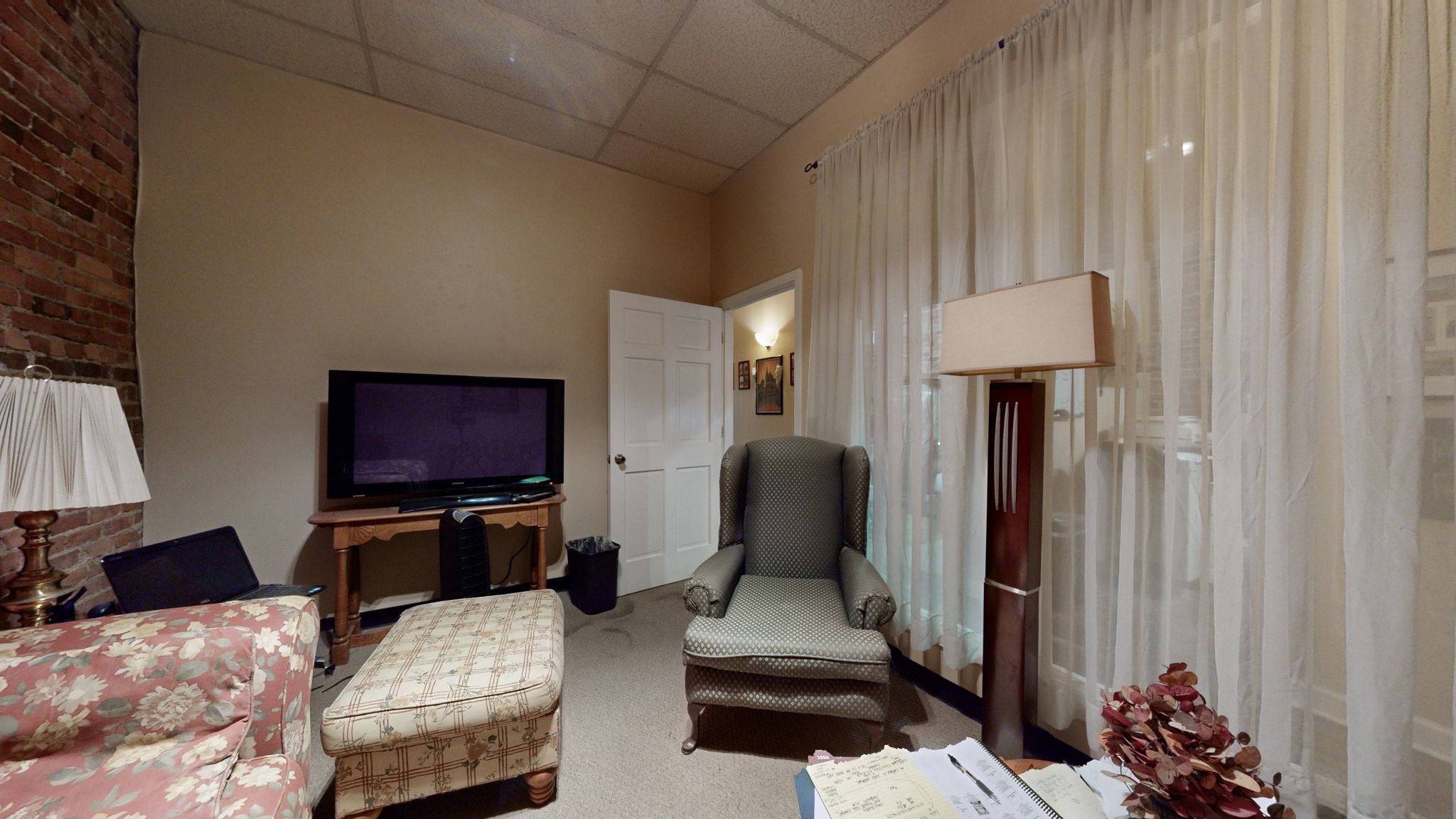 208 3rd Avenue North, Unit 400 Nashville, TN 37201 - Photo 22 of 40 a living room with furniture a flat screen tv and a window
