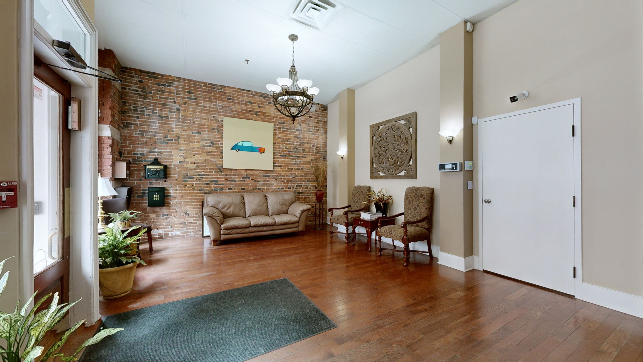 208 3rd Avenue North, Unit 400 Nashville, TN 37201 - Photo 4 of 40 a living room with fireplace furniture and a chandelier