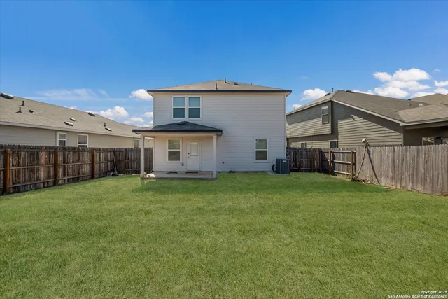 a view of a house with backyard and garden