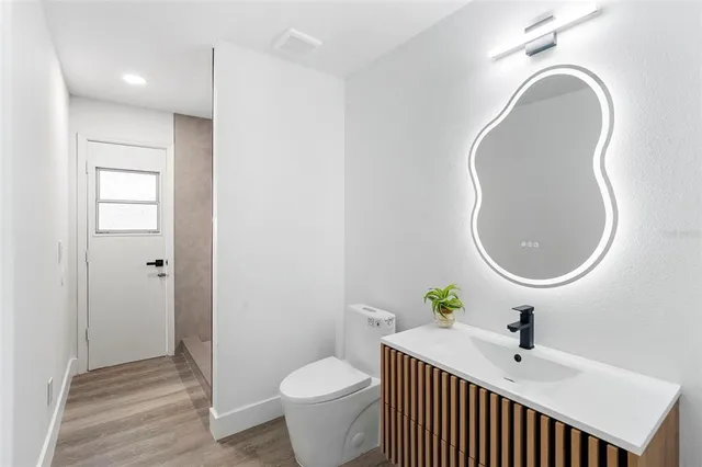 an empty room with wooden floor and white doors