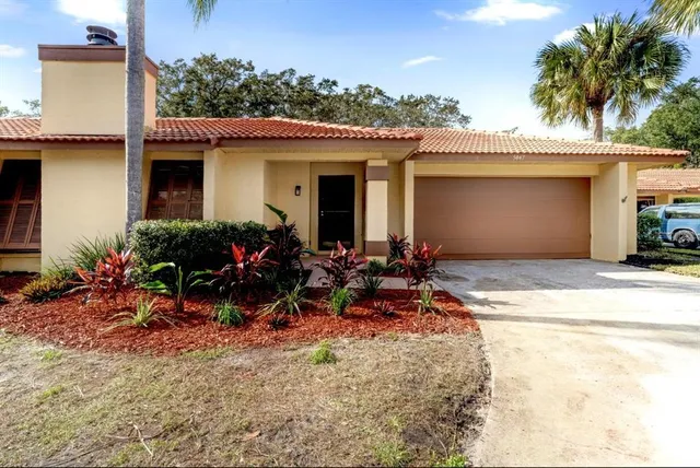 a view of an empty room with wooden floor and a fireplace