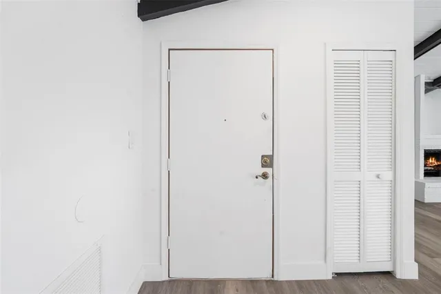 a living room with furniture a fireplace and a chandelier