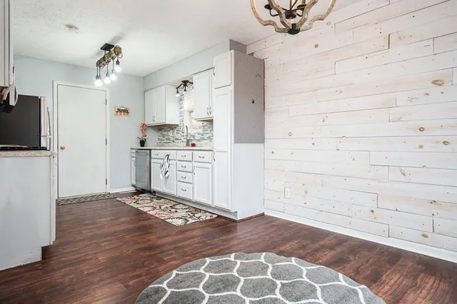 a view of kitchen with cabinets and wooden floor