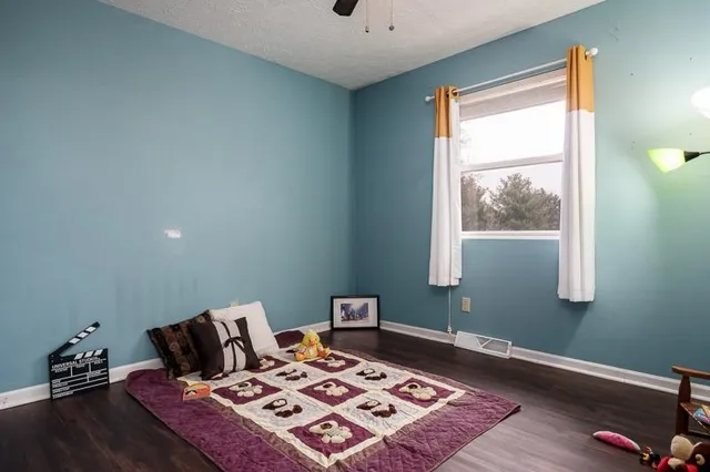 a bed sitting in a bedroom next to a window