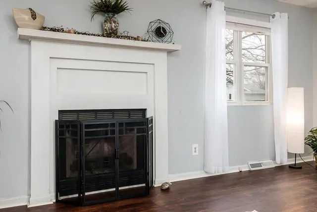 a utility room with a window and wooden floor