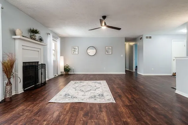 a view of an empty room and wooden floor