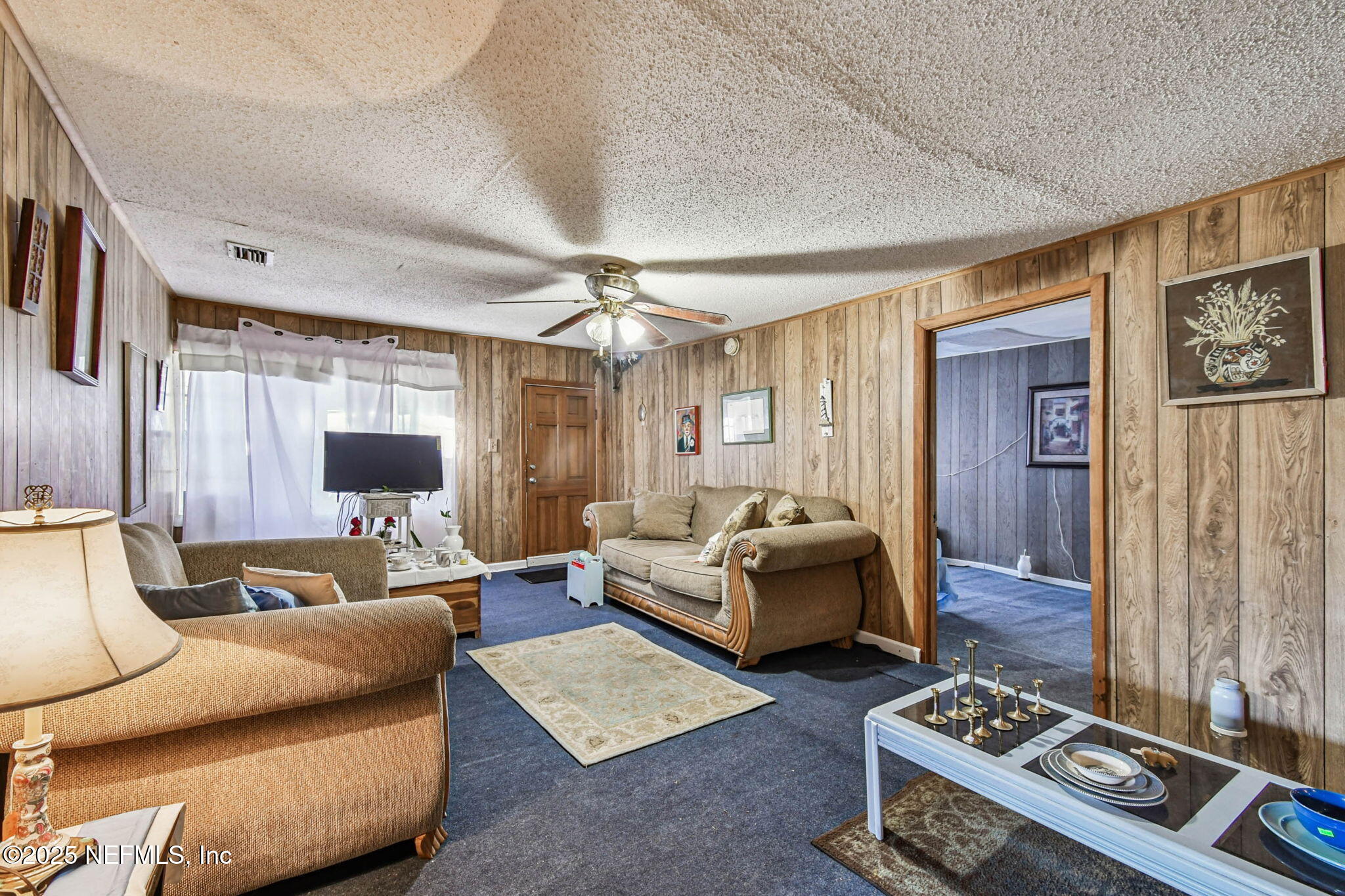 309 Hatten Lane Hastings, FL 32145 - Photo 12 of 28 a living room with furniture and a flat screen tv