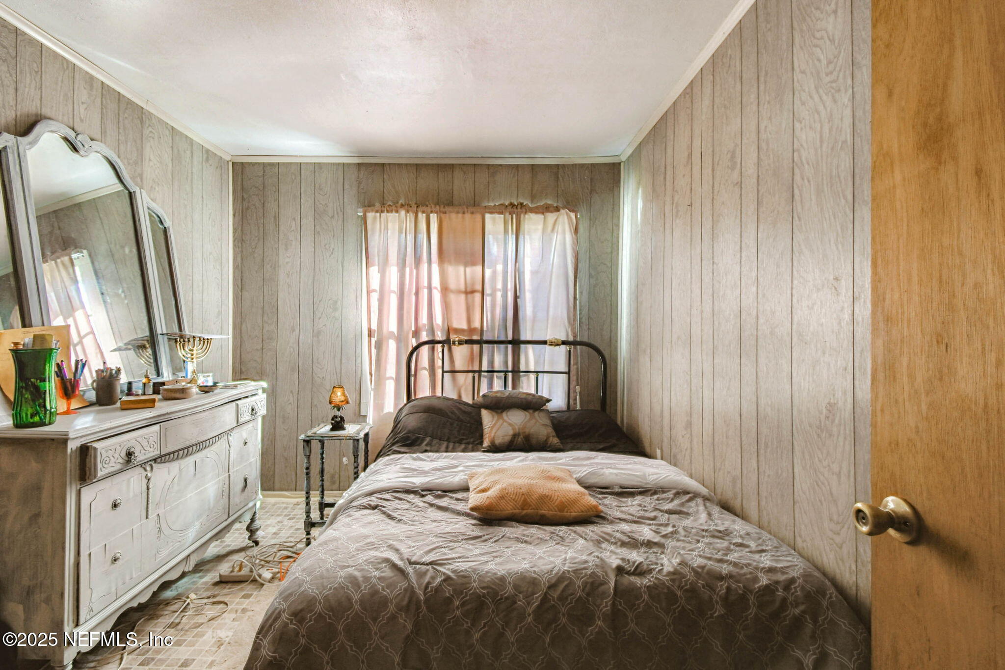 309 Hatten Lane Hastings, FL 32145 - Photo 18 of 28 a bedroom with a large bed and a window