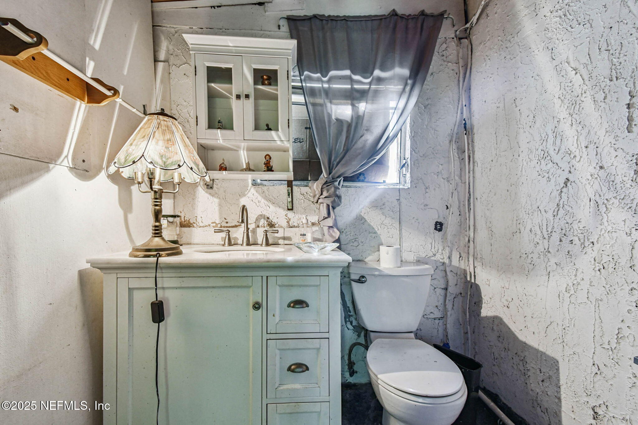 309 Hatten Lane Hastings, FL 32145 - Photo 24 of 28 a bathroom with a toilet sink and mirror