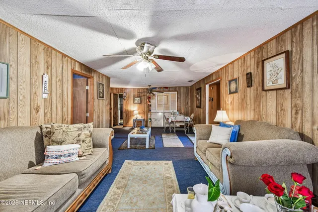 a kitchen with granite countertop a sink a stove and cabinets