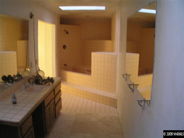 2155 Piute Creek Road Reno, NV 89510 - Photo 7 of 8 a bathroom with a granite countertop sink a mirror and a shower