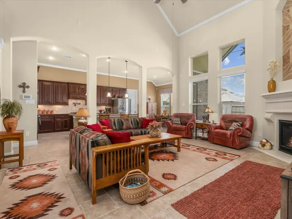 a living room with furniture fireplace and rug