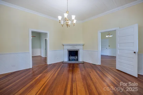 a view of an empty room and wooden floor