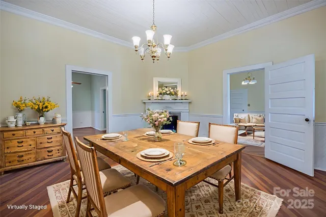 a view of a dining room with furniture and chandelier