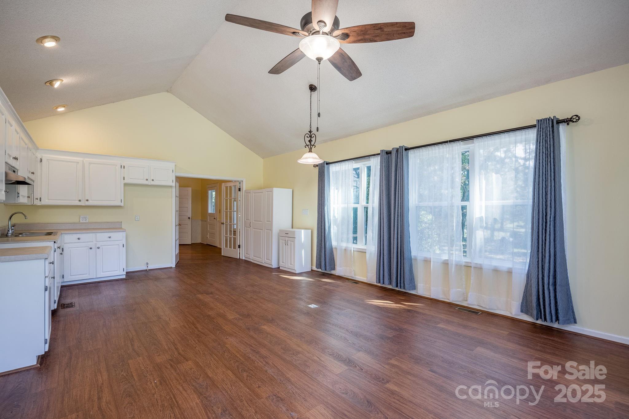 2086 State Rd S-20-19 Winnsboro, SC 29180 - Photo 14 of 30 a view of a kitchen with wooden floor and a ceiling fan