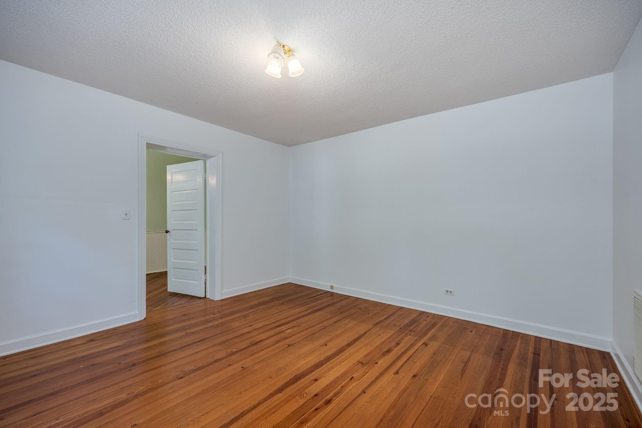 2086 State Rd S-20-19 Winnsboro, SC 29180 - Photo 17 of 30 an empty room with wooden floor and windows