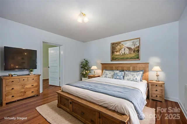 a bedroom with a bed and a flat screen tv