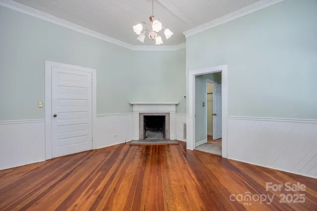 wooden floor in an empty room with a fireplace