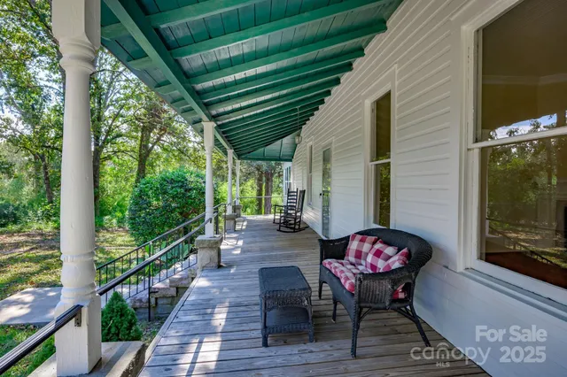 a view of a chairs and table in the balcony