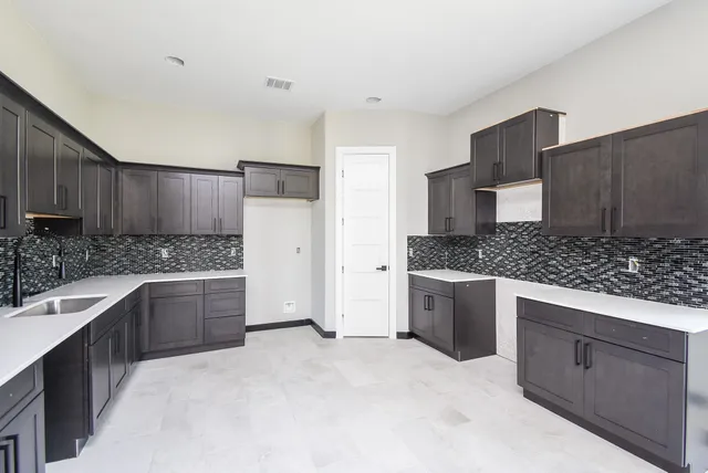 a large kitchen with a stove top oven a sink and dishwasher