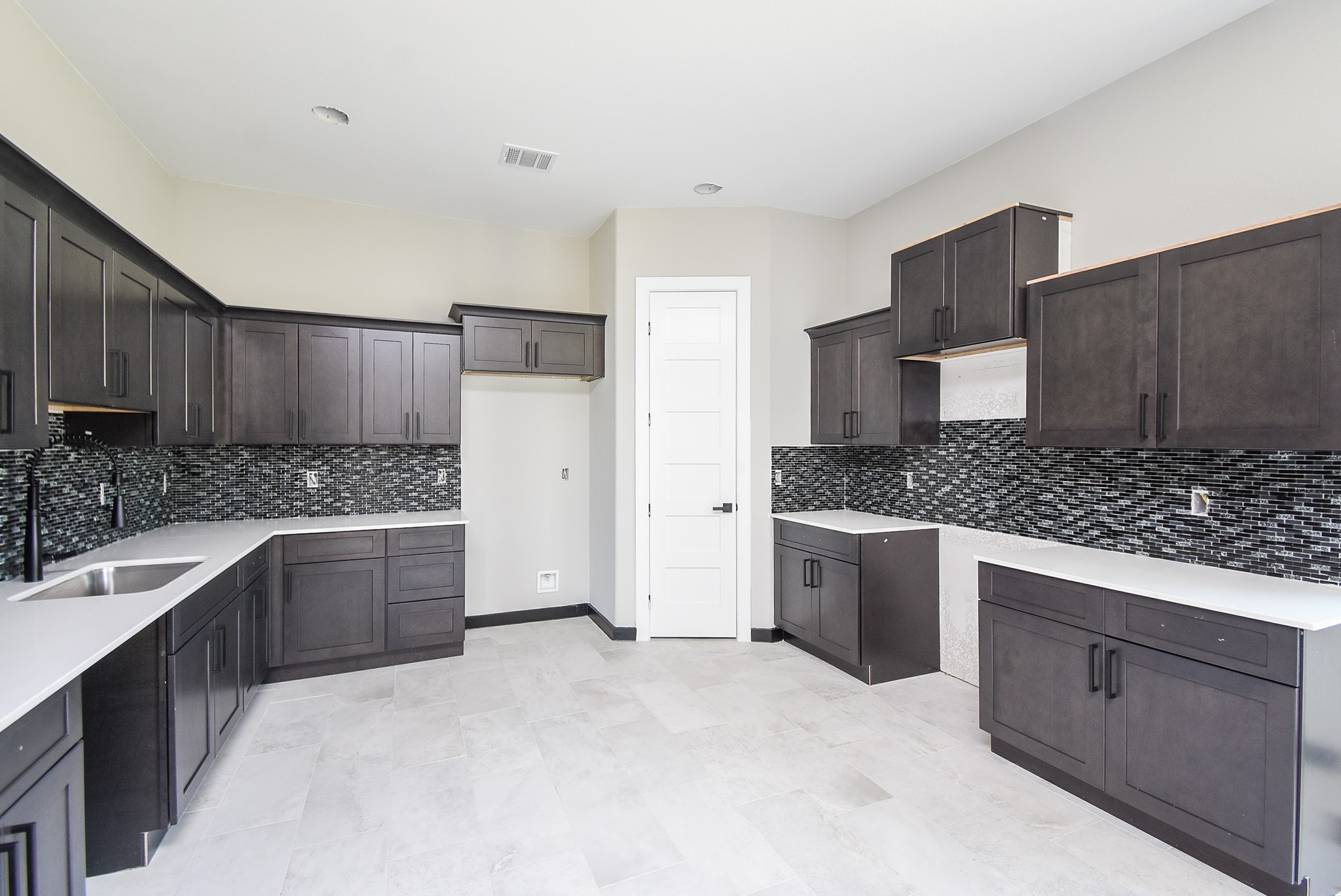 a large kitchen with a stove top oven a sink and dishwasher