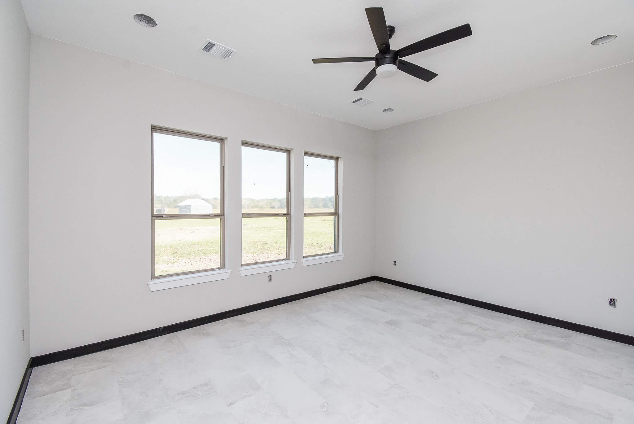 208 Silverleaf Road Sweeny, TX 77480 - Photo 27 of 49 an empty room with a window and a fan