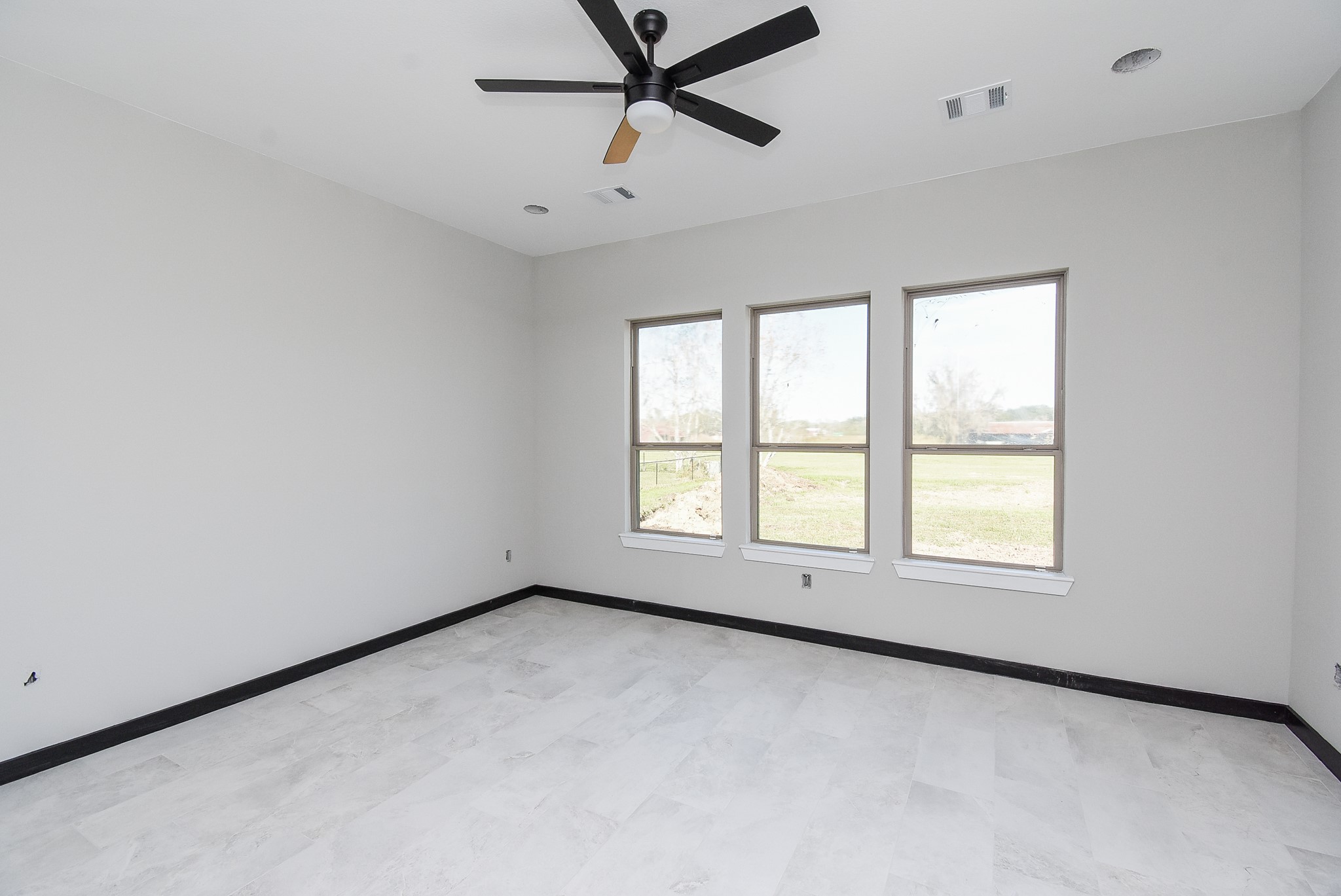 208 Silverleaf Road Sweeny, TX 77480 - Photo 28 of 49 an empty room with a window and a fan