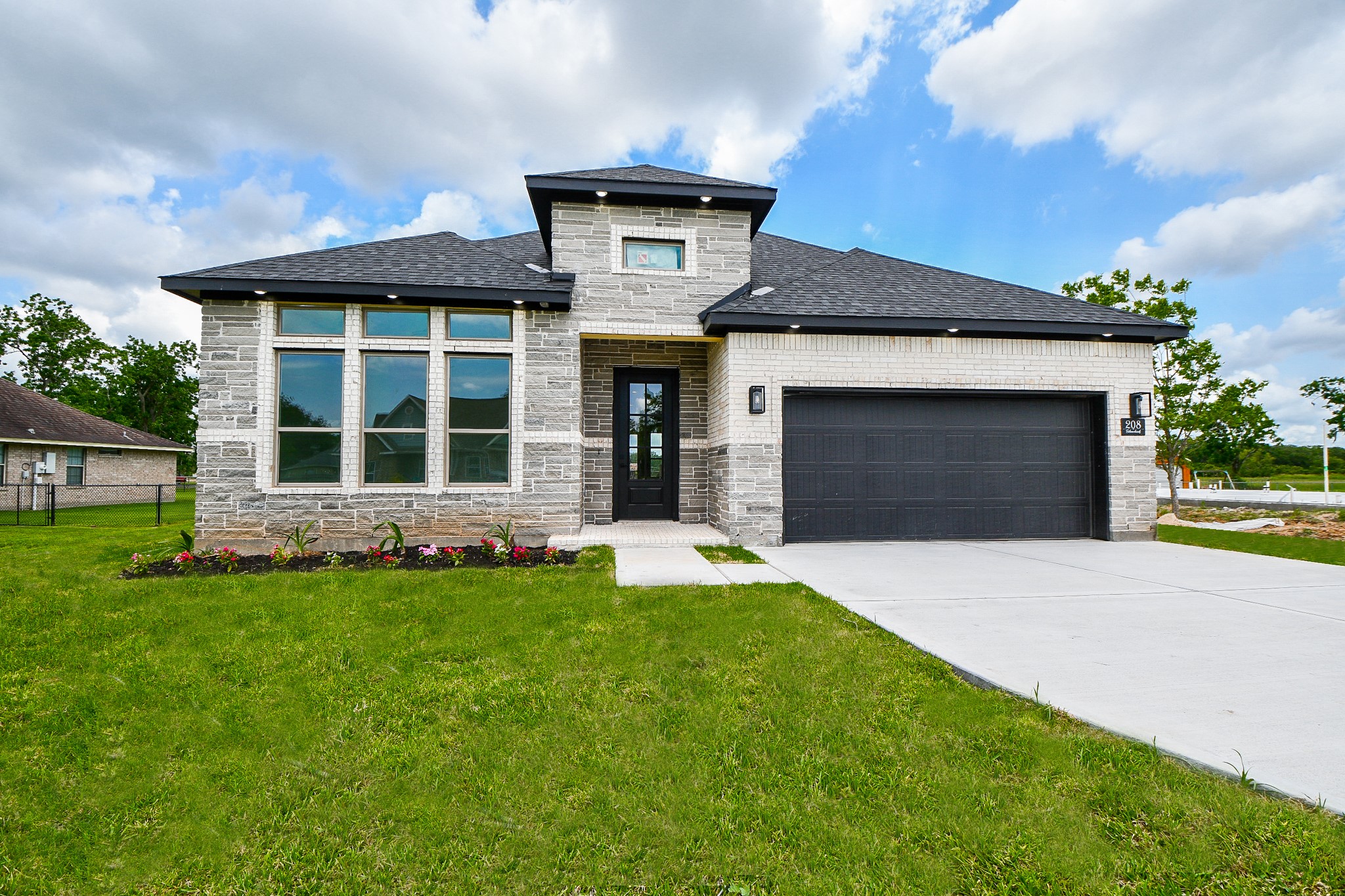 208 Silverleaf Road Sweeny, TX 77480 - Photo 3 of 49 a front view of a house with a yard and garage