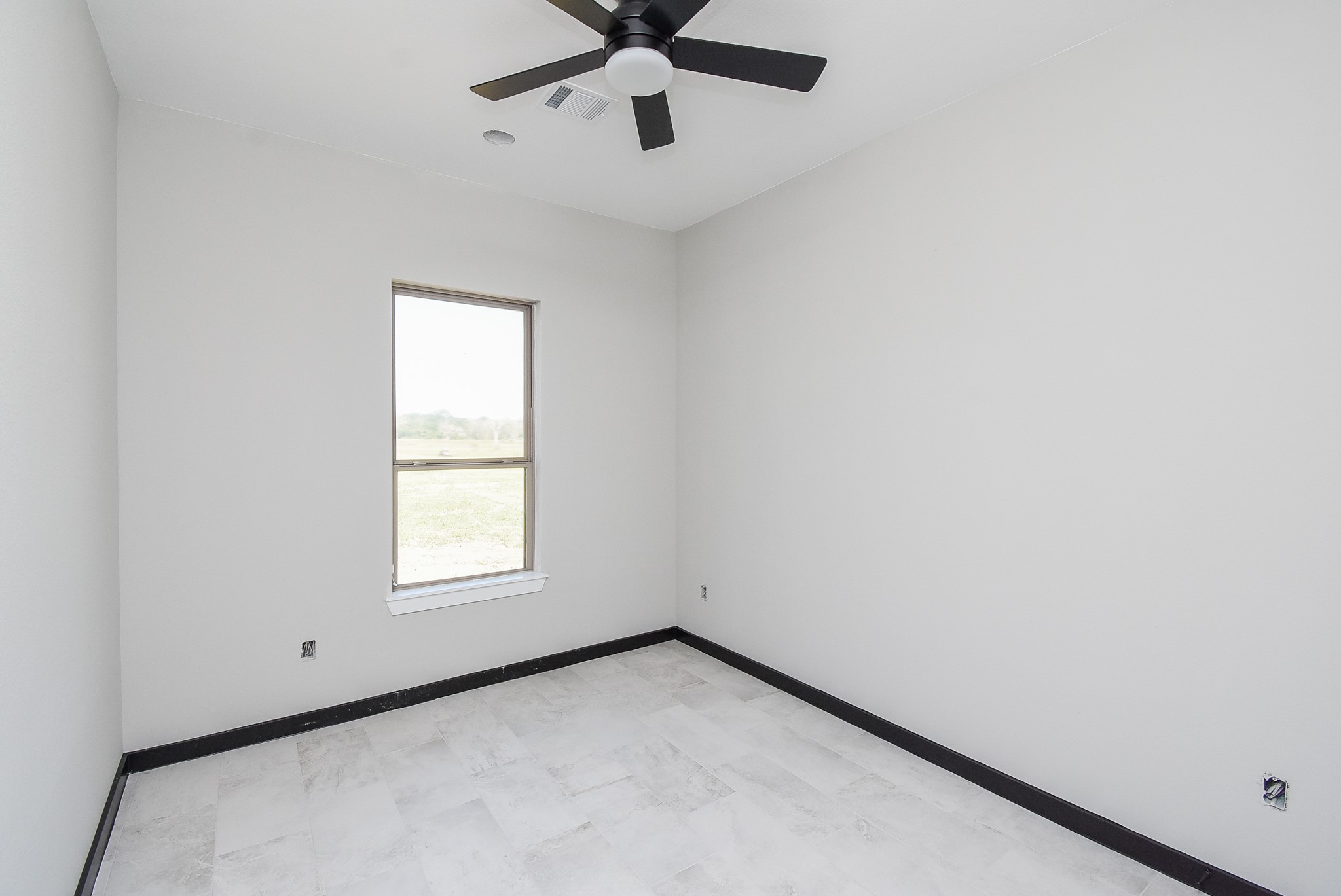 208 Silverleaf Road Sweeny, TX 77480 - Photo 43 of 49 an empty room with a window and a fan
