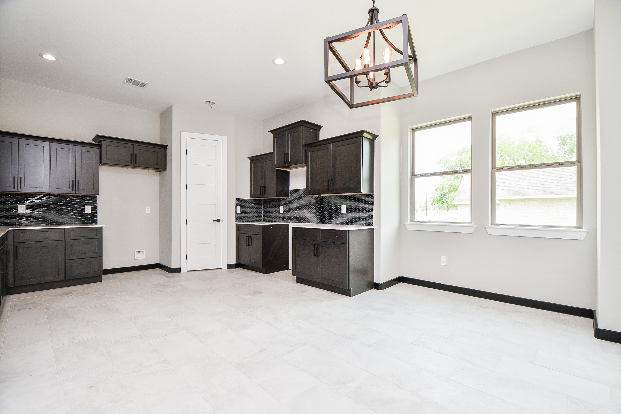 208 Silverleaf Road Sweeny, TX 77480 - Photo 5 of 49 a kitchen with stainless steel appliances kitchen island granite countertop a stove a sink and a microwave