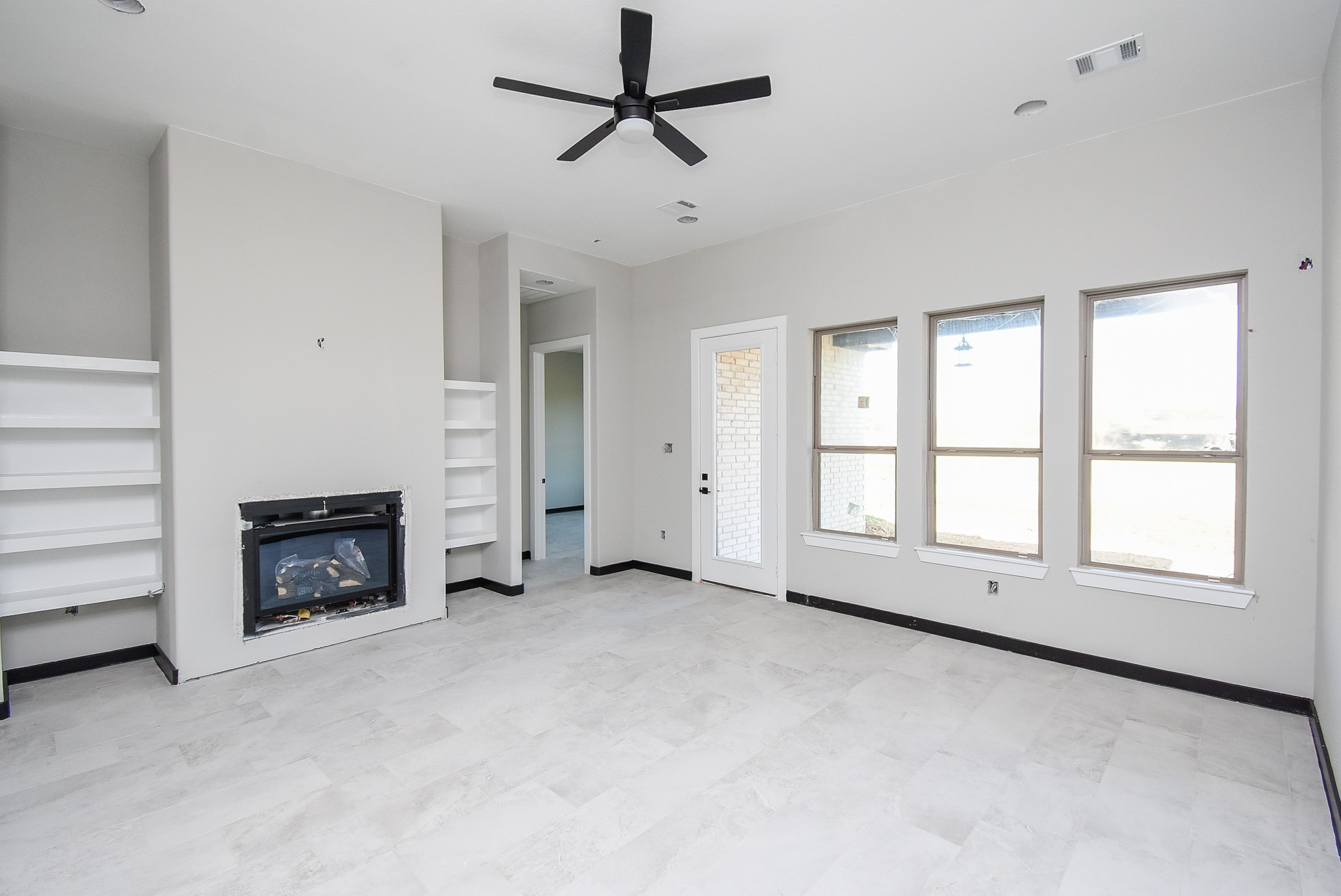 208 Silverleaf Road Sweeny, TX 77480 - Photo 6 of 49 an empty room with windows and fireplace