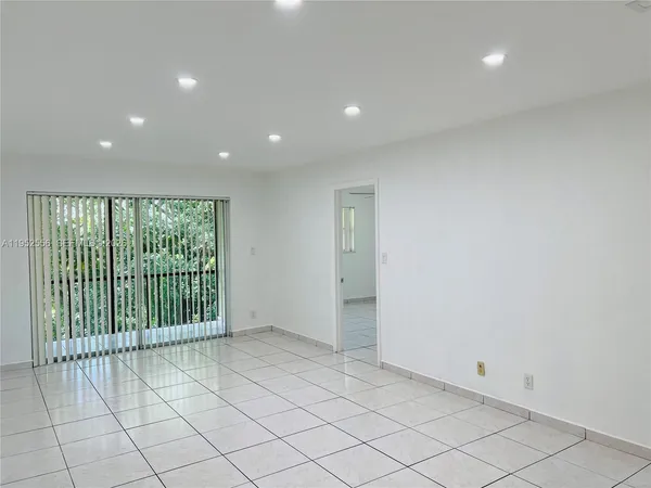 a view of an empty room and a window
