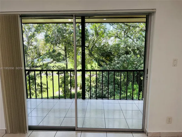 a view of a balcony with yard