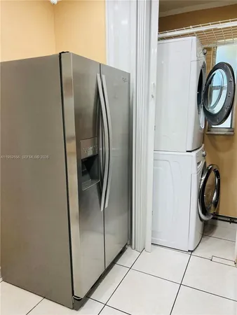 a metallic refrigerator freezer sitting in a kitchen