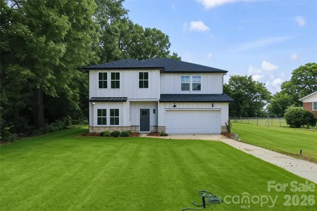a view of a house with a yard and sitting area