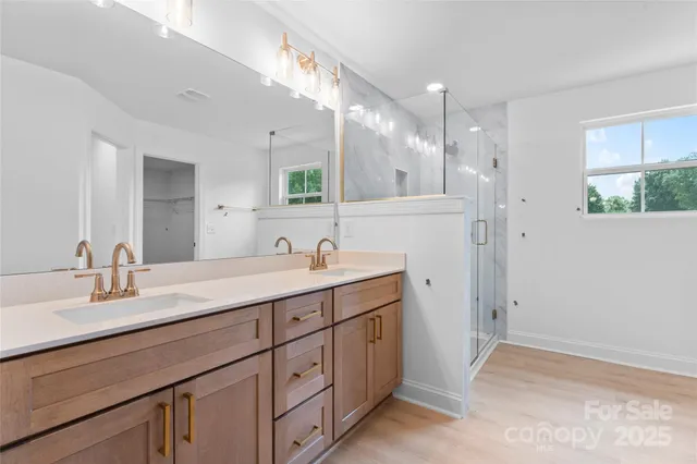 a bathroom with a double vanity sink and mirror
