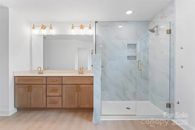 a bathroom with a shower sink and mirror
