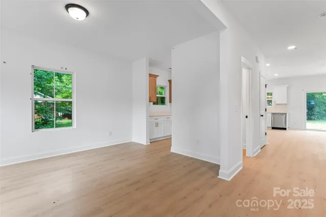 an empty room with windows and closet