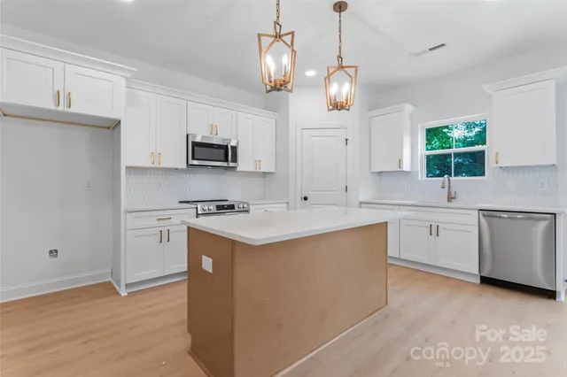 a kitchen with a sink stove and microwave