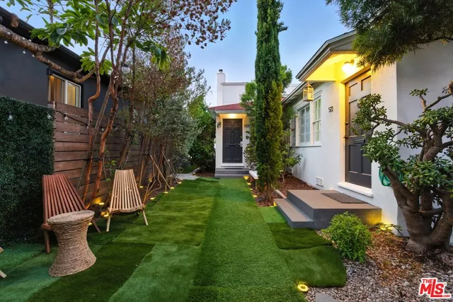 a view of a house with a yard and garden